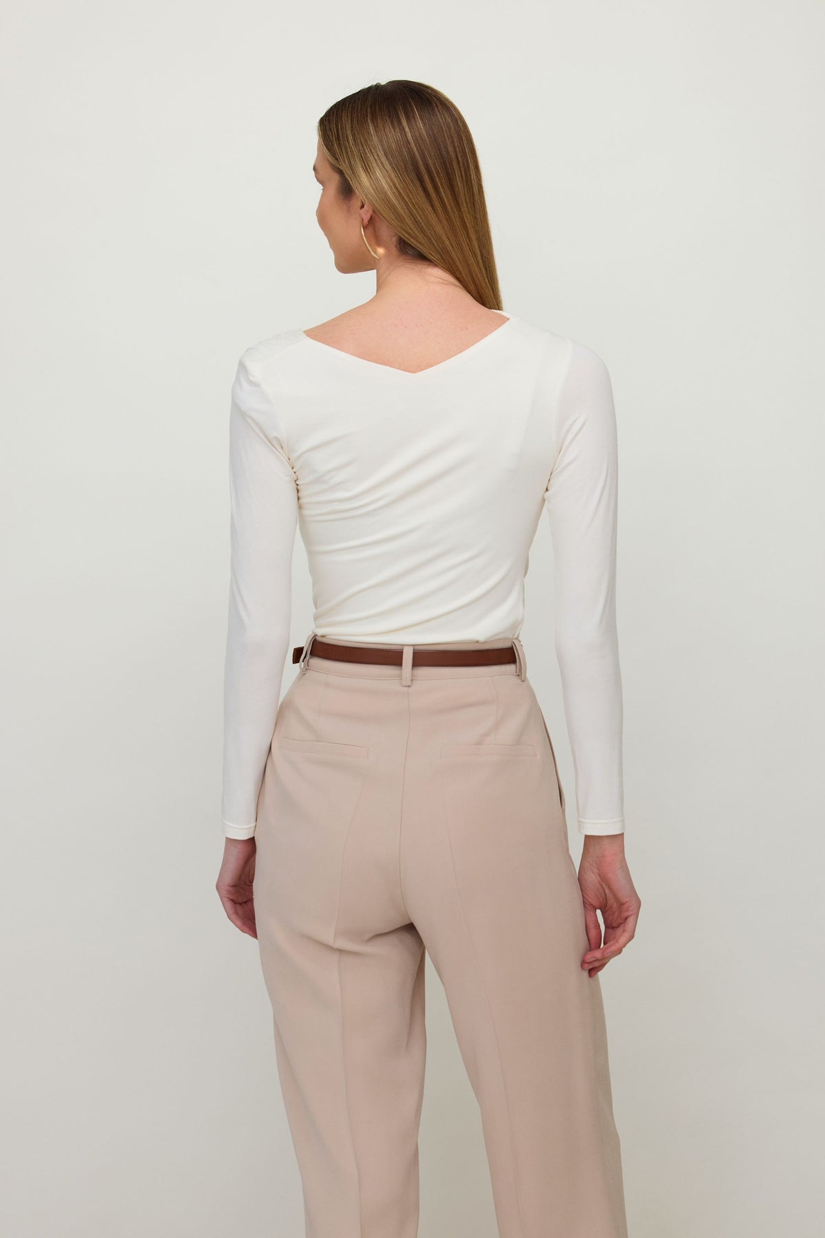 Brown long sleeve blouse with asymmetric neckline and draping